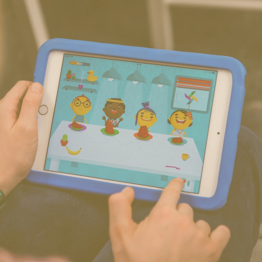 Tablet game where a child shares food between the characters.